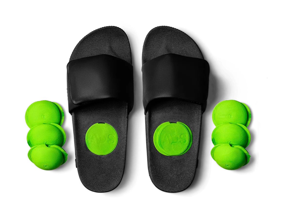 Black AVOS Therapy Slides V3.1 with removable green massage inserts on a transparent background