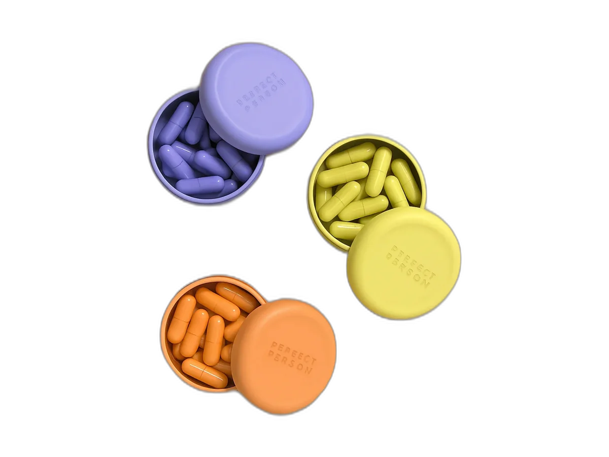 First Person The Collection with three formula tins and capsules on a transparent background.