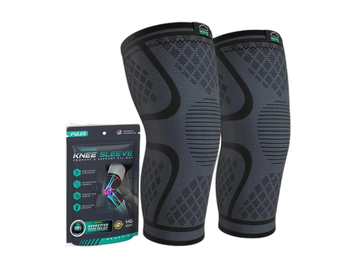 Pair of black MODVEL compression knee sleeves with the branded box isolated on a transparent background