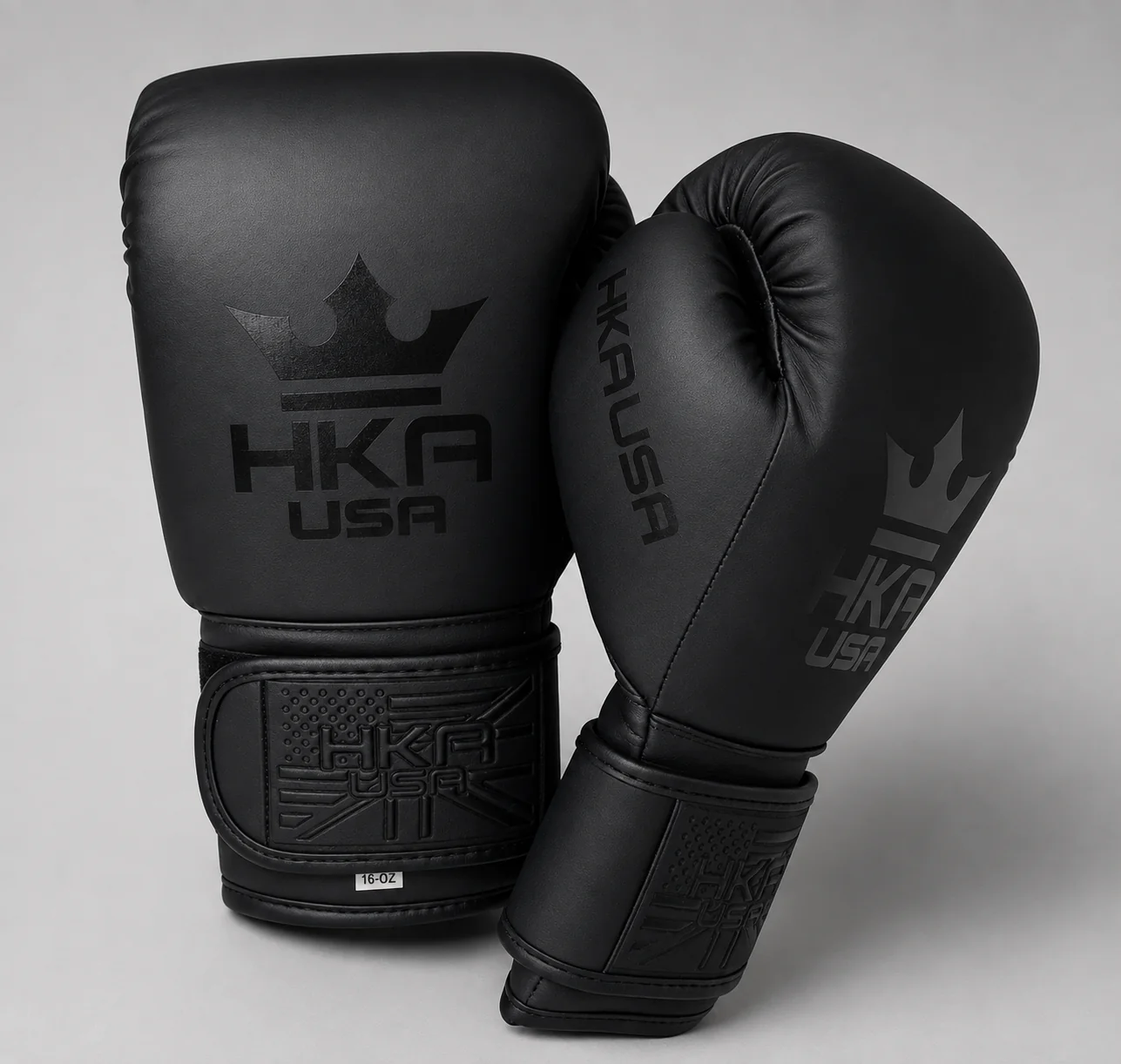 HKA USA MIDNIGHT matte-black boxing gloves photographed against a gray studio background.