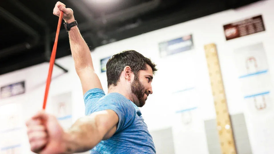 Athlete training with a Power Systems resistance band