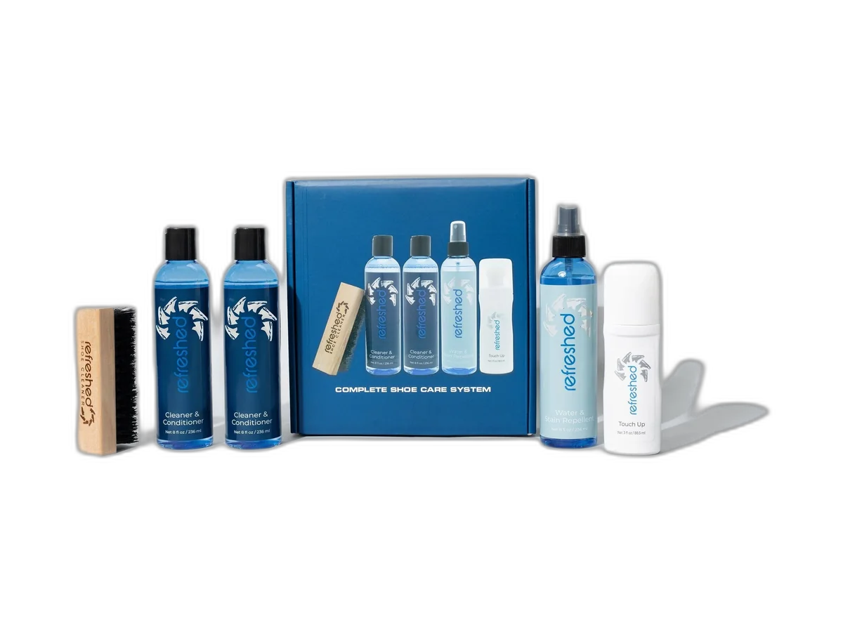 Refreshed Complete Shoe Care Kit bottles, brush and box isolated on a transparent background
